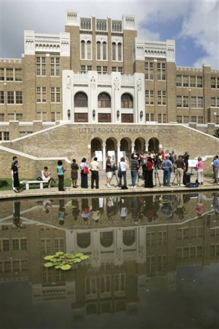 The image of Little Rock Central High School is reflected in a pond during a news conference in Little Rock, Ark., on July 16, 2007. Nine black students desegregated the school in September 1957. 